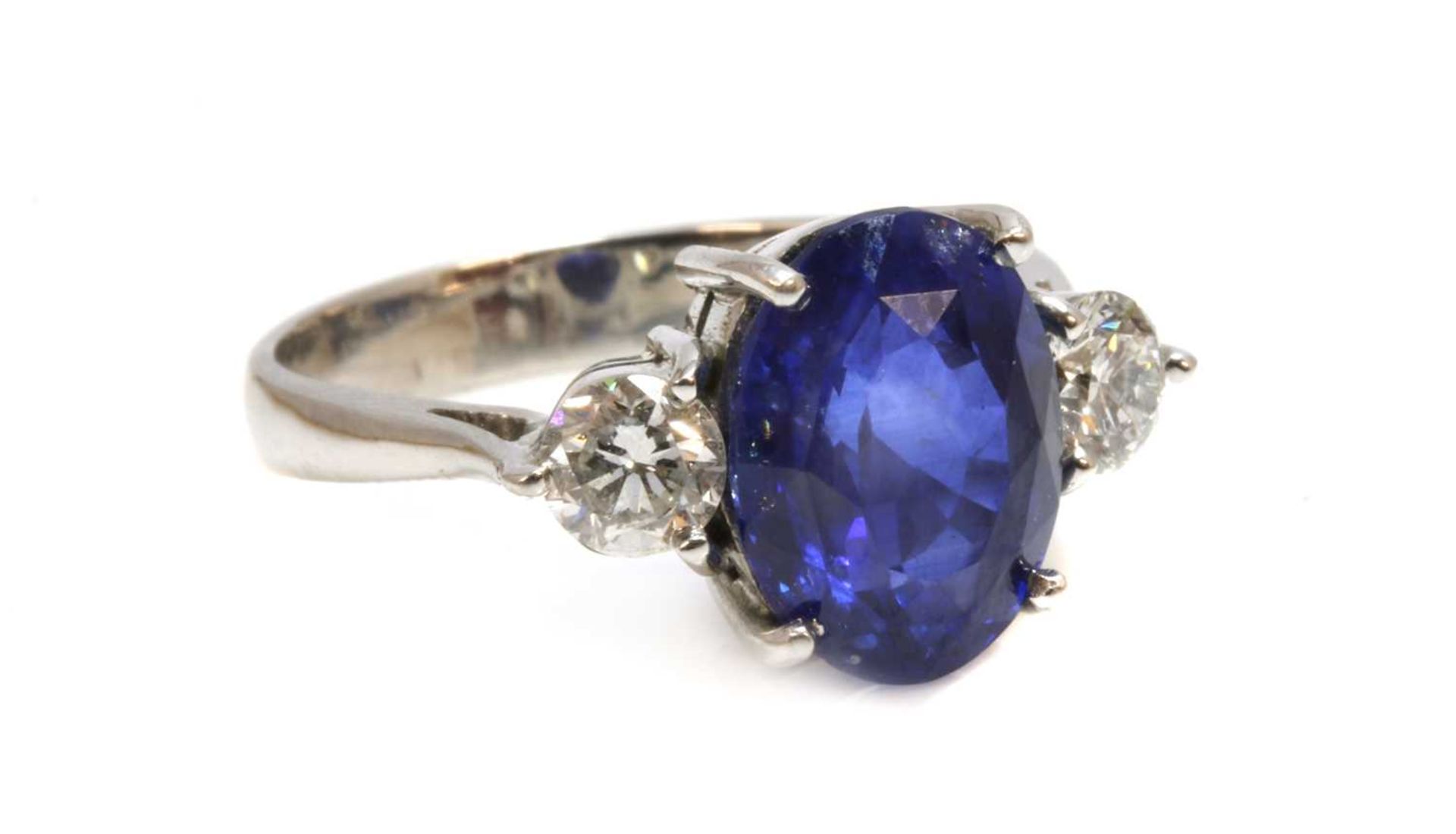 An 18ct white gold sapphire and diamond three stone ring,