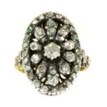 A gold and silver diamond oval cluster ring,