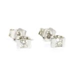 A pair of white gold single stone diamond stud earrings,