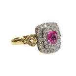 An 18ct gold pink sapphire and diamond cushion-shaped halo cluster ring,