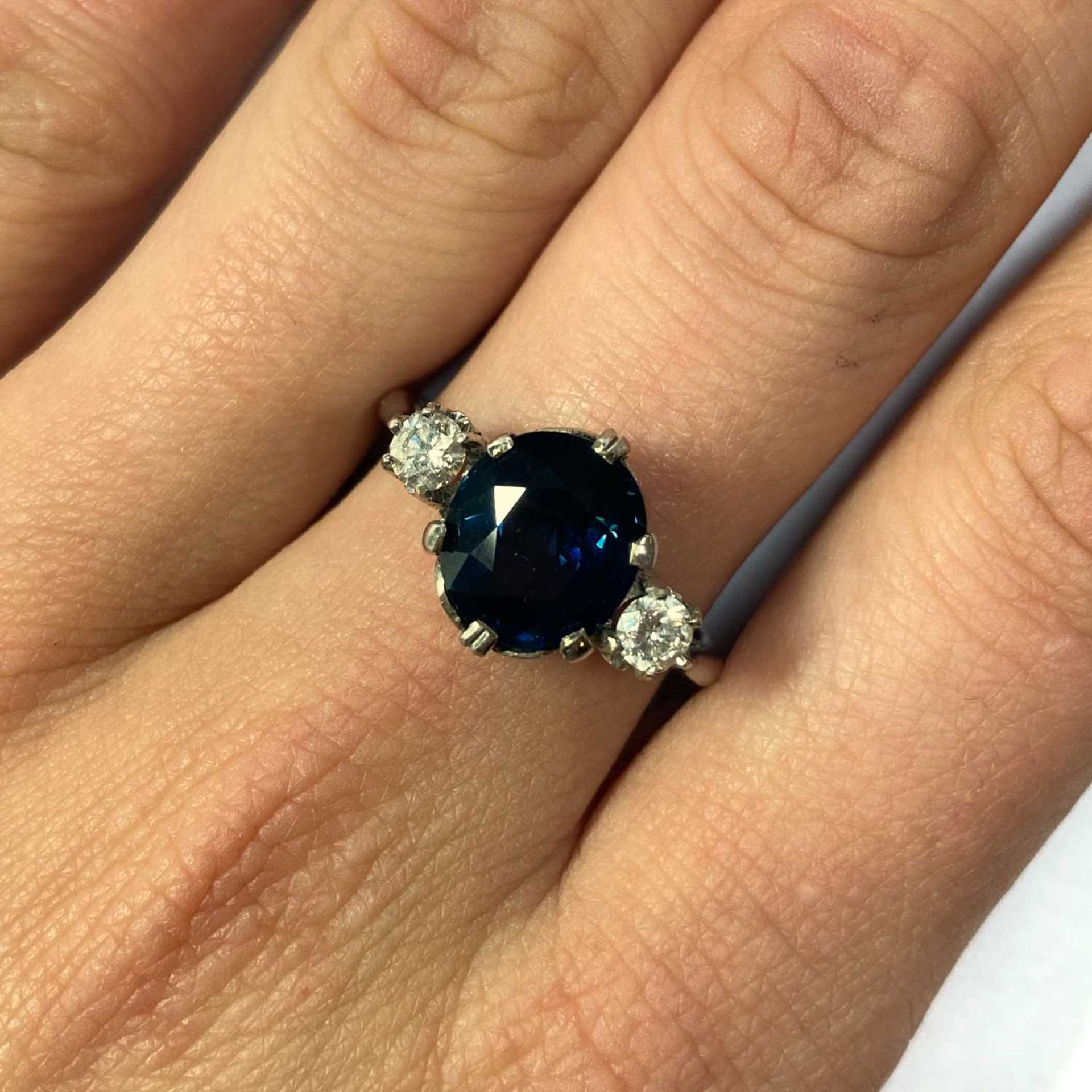 An 18ct white gold sapphire and diamond three stone ring, - Image 2 of 2