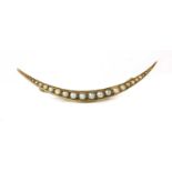 An Edwardian gold split pearl open crescent brooch,