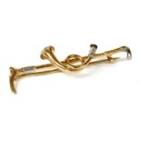 A gold and platinum hunting horn brooch,