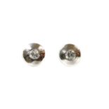 A pair of white gold single stone diamond stud earrings,