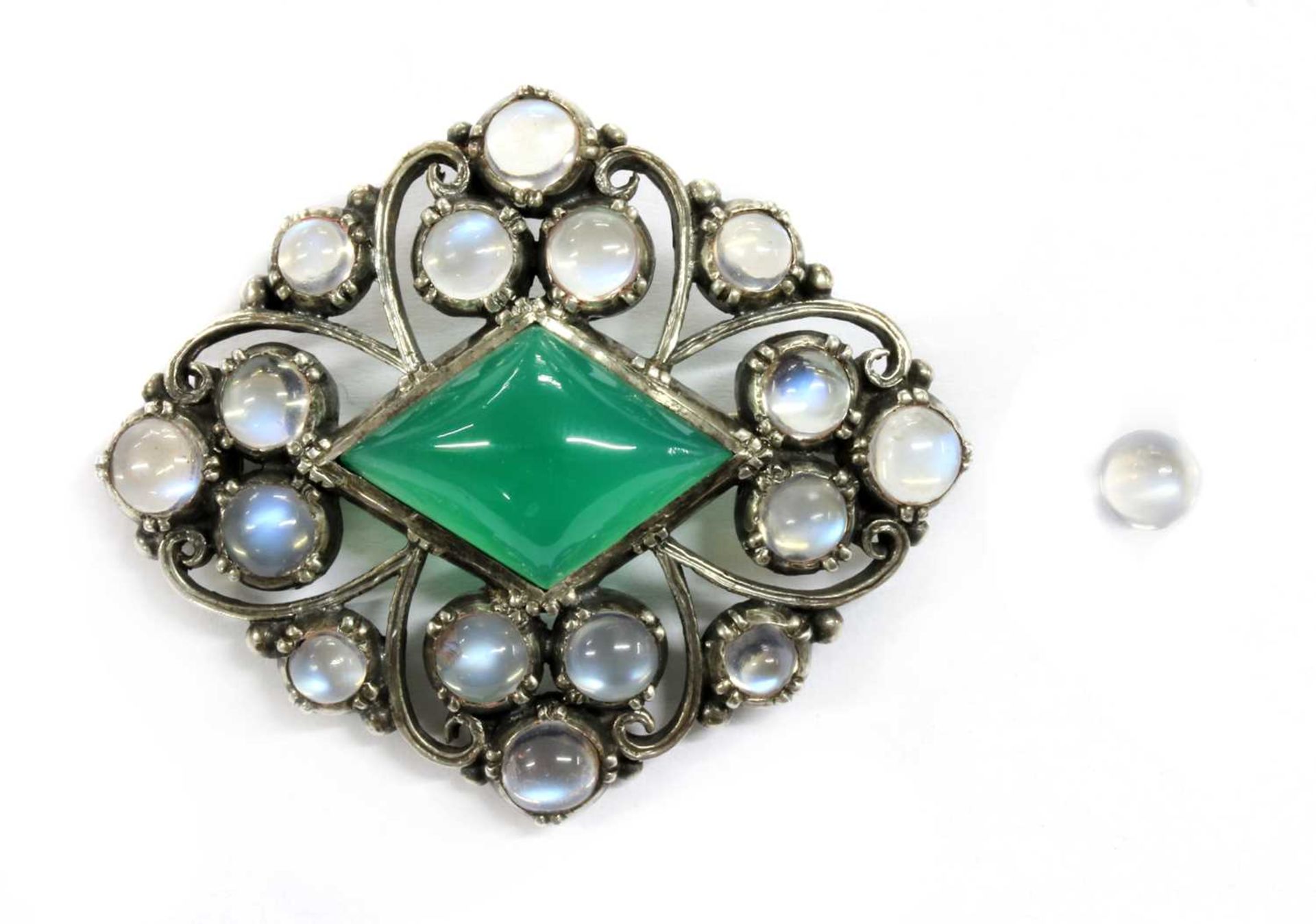 An Arts & Crafts silver dyed green agate and moonstone brooch,