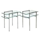 A pair of chrome and glass side tables,