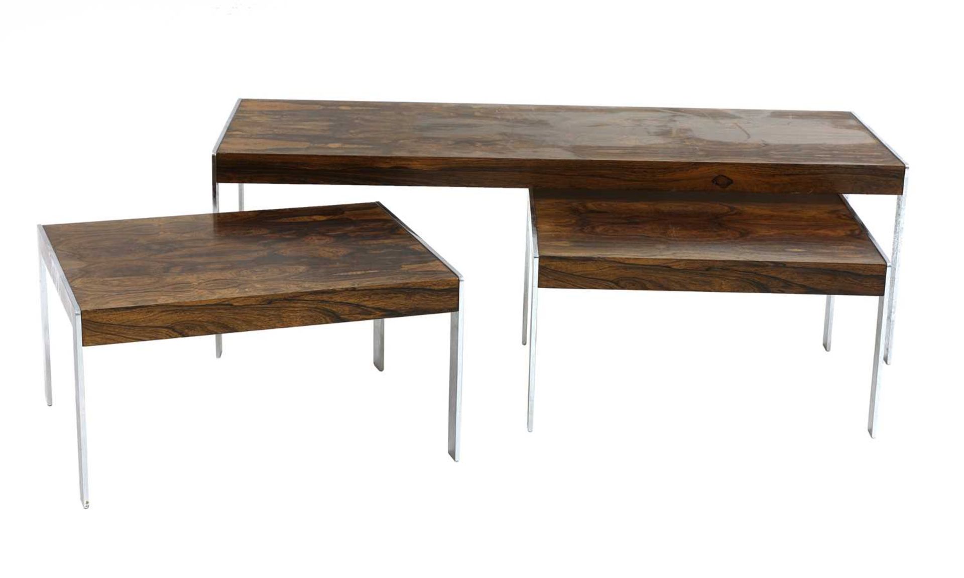 A Merrow Associates' rosewood and chrome nest of three tables, §