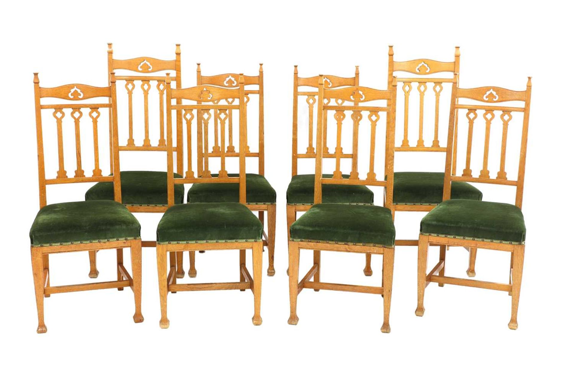 A set of eight Arts and Crafts oak dining chairs,