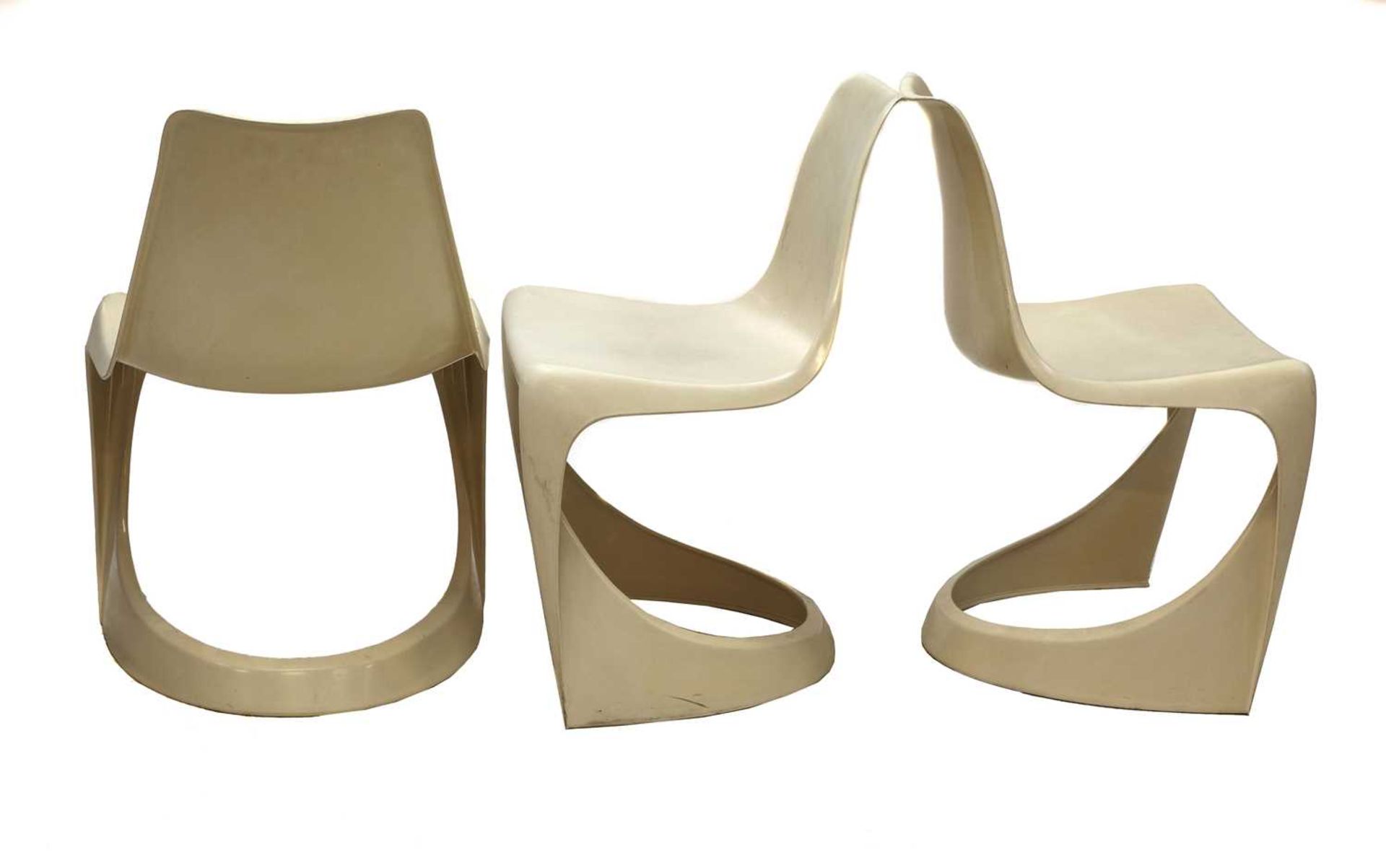 Three Cado moulded plastic stacking chairs,