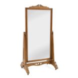 An Arts and Crafts oak cheval mirror,