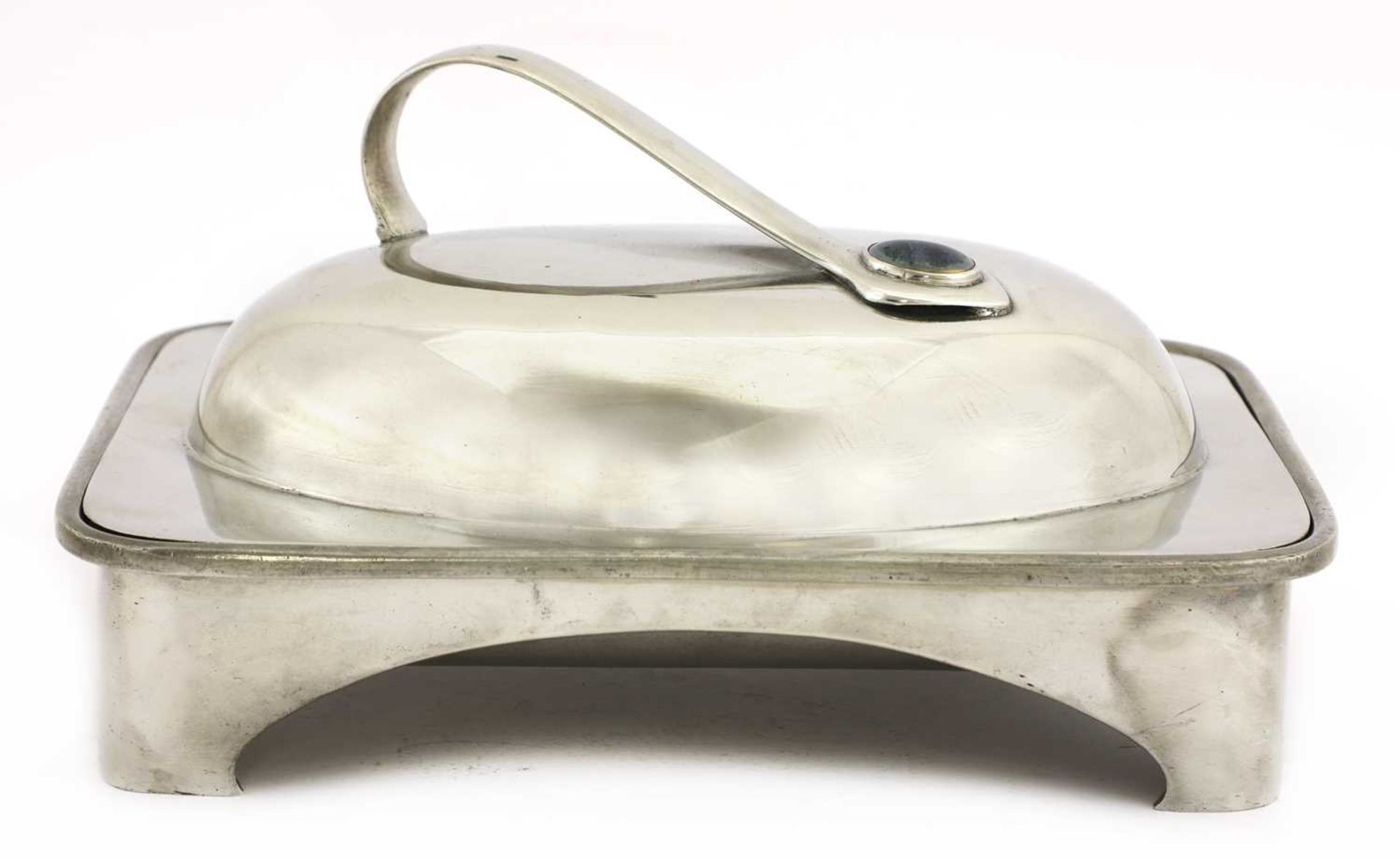 An Arts and Crafts pewter muffin dish and cover,