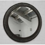 An industrial metal circular mirror,