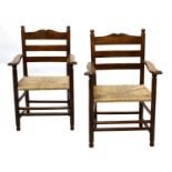 A pair of rare Gordon Russell yew wood ladderback chairs,