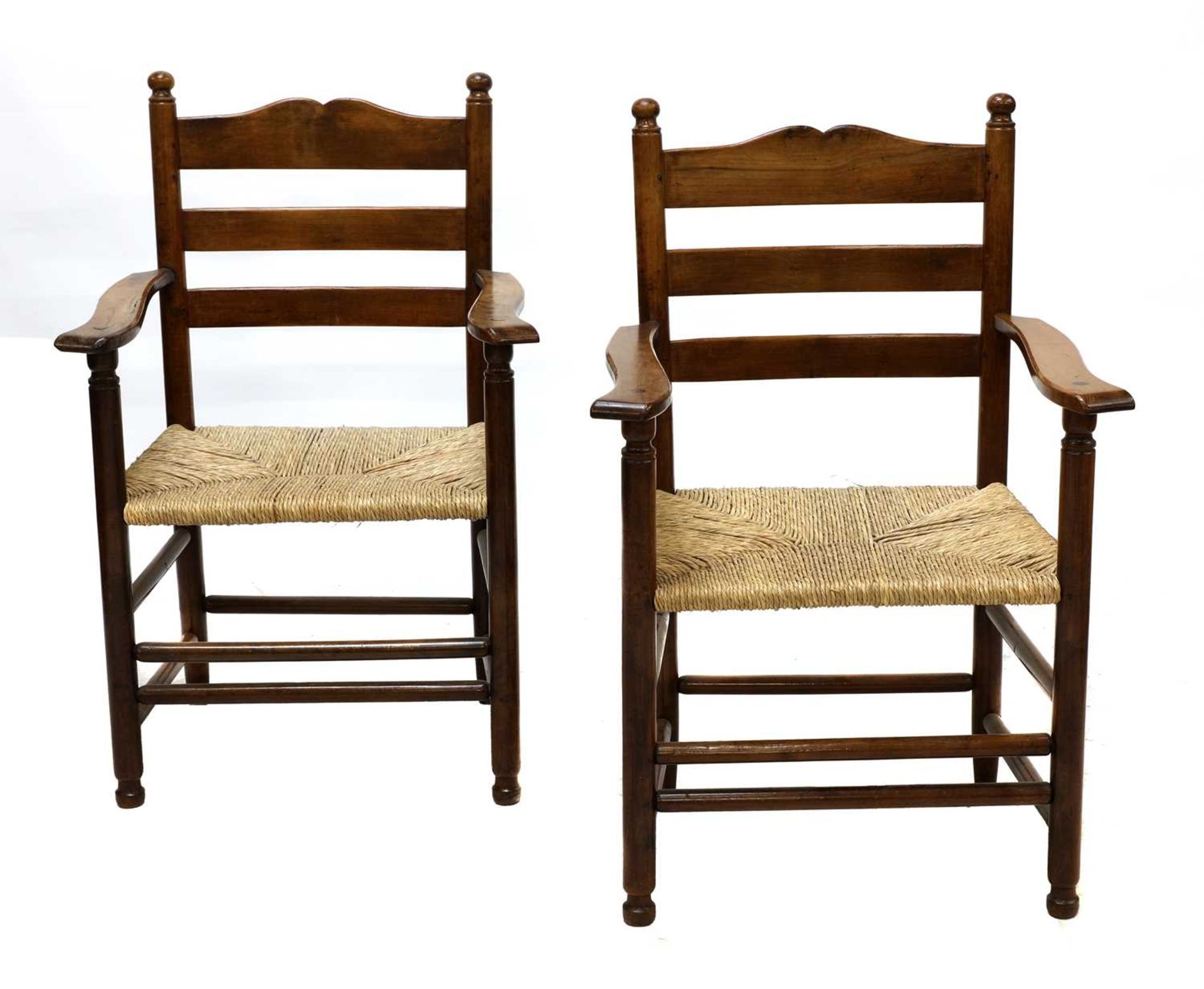 A pair of rare Gordon Russell yew wood ladderback chairs,