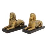 A pair of patinated bronze sphinx bookends,