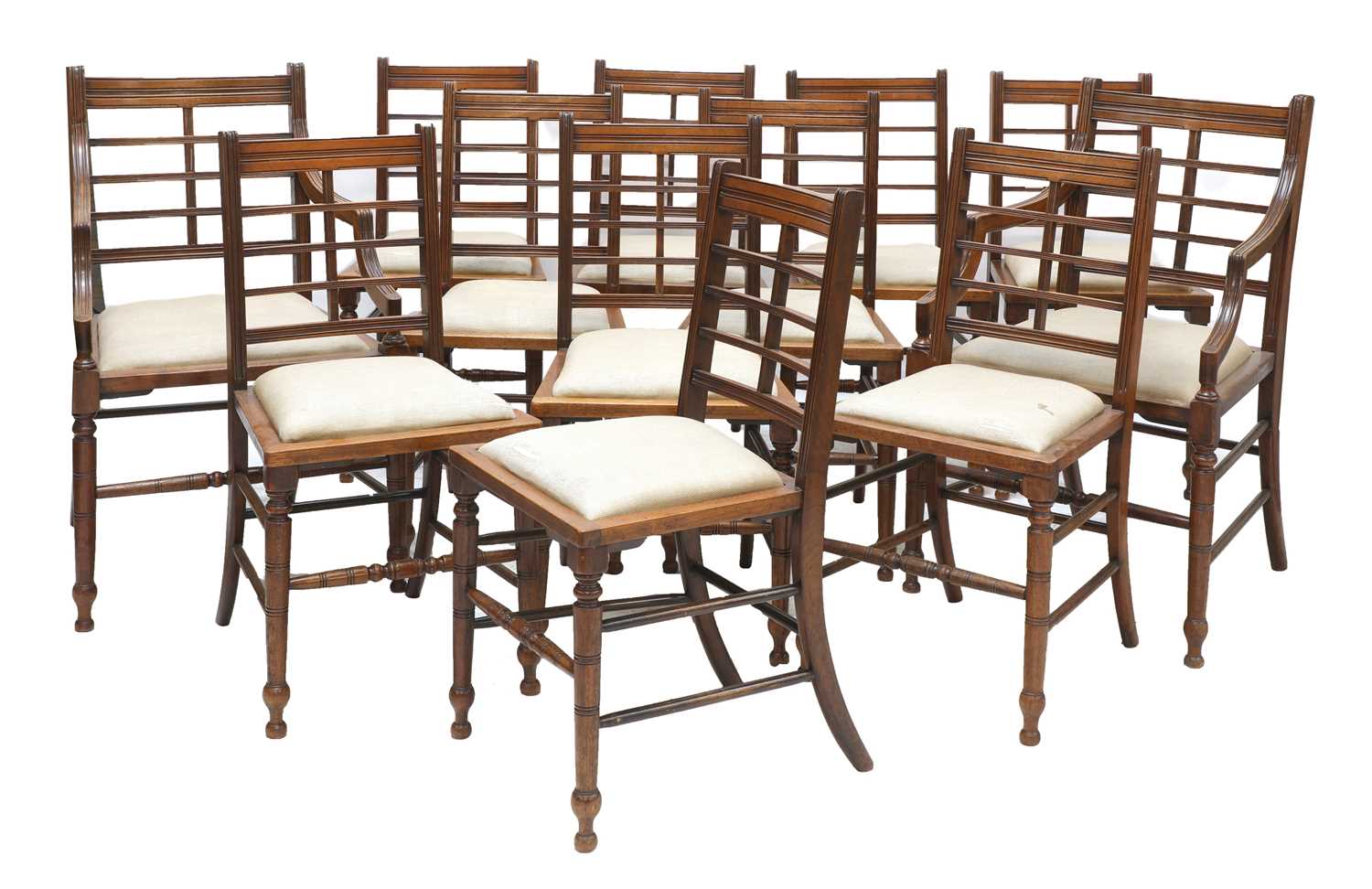 A set of twelve Arts and Crafts walnut chairs,