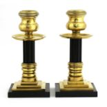 A pair of bronze and Bakelite candlesticks,