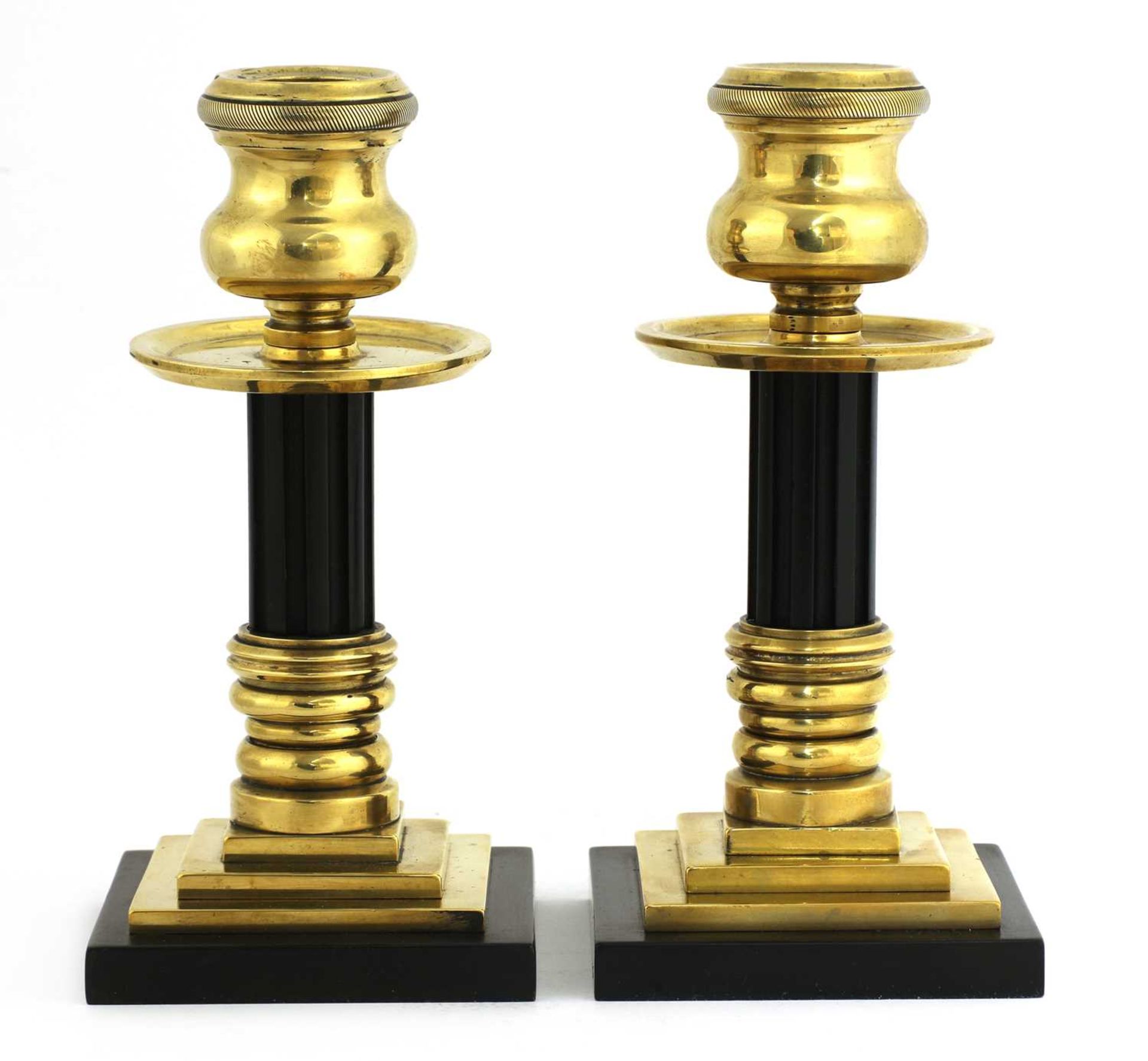 A pair of bronze and Bakelite candlesticks,