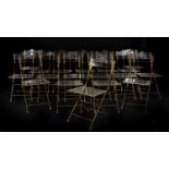 A set of eighteen Lucite and gilt metal folding chairs,