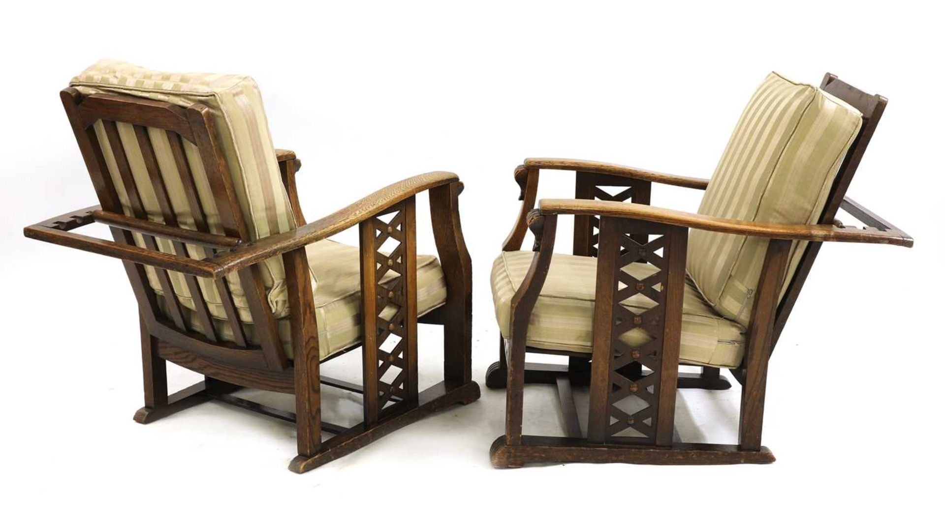 A pair of Art Deco oak reclining armchairs,