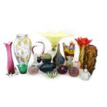A collection of thirty coloured glass vases and bowls,