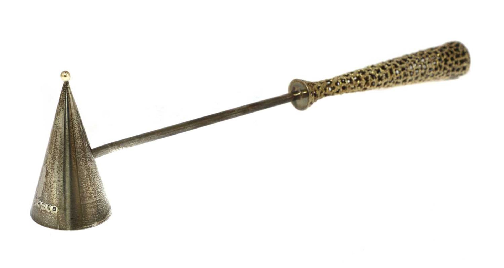 A silver gilt candle snuffer,