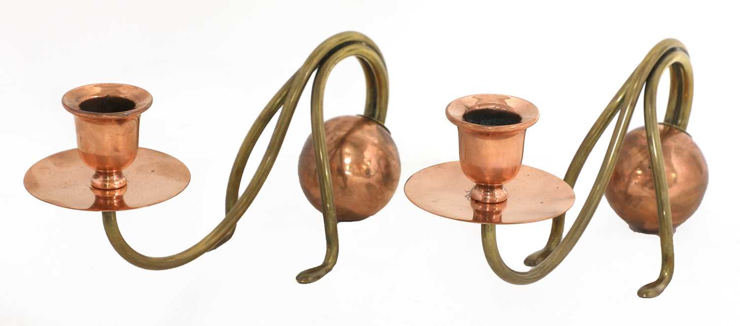 A pair of Arts and Crafts copper and brass candlesticks,