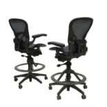A pair of tall office chairs,