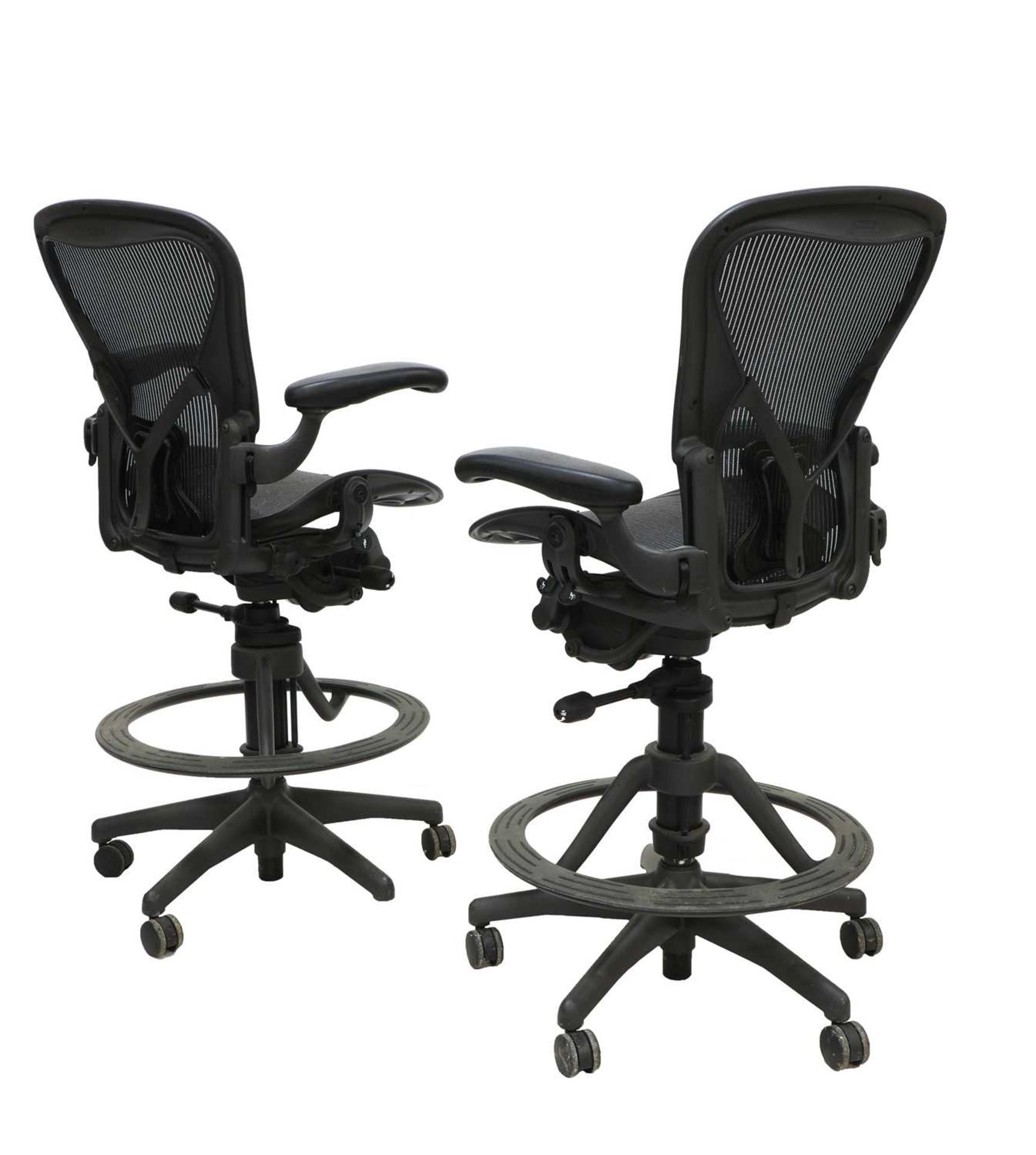 A pair of tall office chairs,