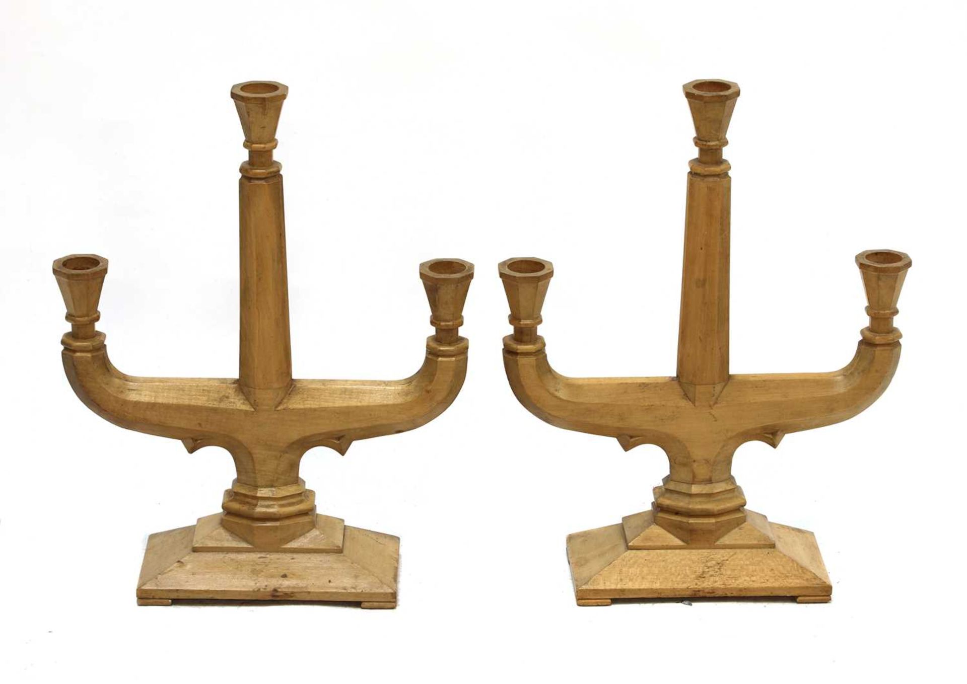 A pair of fruitwood three-branch candelabra,