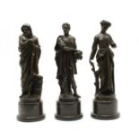 Three bronzed figures,
