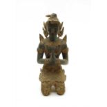 A bronze figure of a kneeling deity
