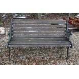 A Victorian design cast iron and teak garden bench,