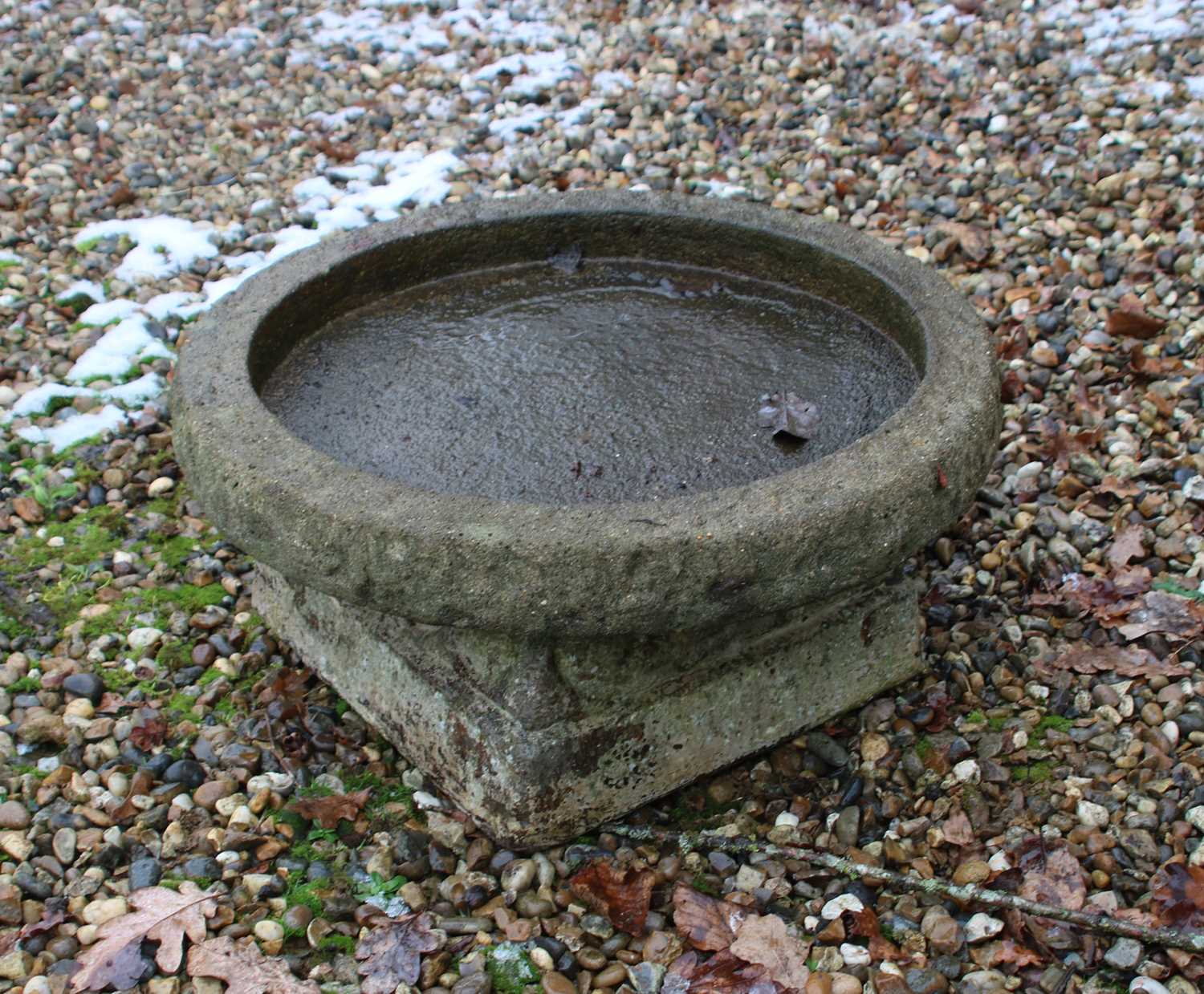 A reconstituted stone bird bath,