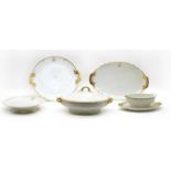 A Limoges porcelain dinner service, white with gold highlights