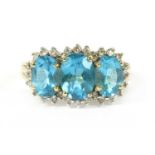 A 9ct gold blue topaz and diamond triple cluster ring,