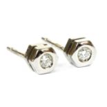 A pair of 18ct white gold single stone diamond stud earrings,