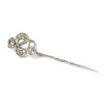 An 18ct white gold diamond set treble clef stick pin, by Theo Fennell,