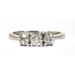 A 9ct white gold three stone diamond ring,