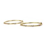 A pair of 9ct gold hollow hinged bangles,