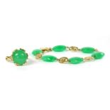 A 14ct gold green jade ring,