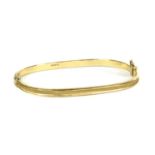 An 18ct gold hollow hinged bangle,