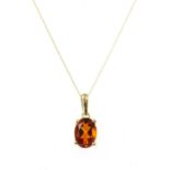 A gold single stone citrine pendant,