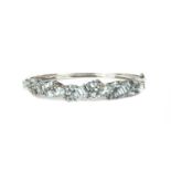 A white gold aquamarine oval hinged bangle,