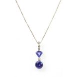 A white gold tanzanite and diamond pendant,