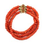 A three row uniform coral bead bracelet,