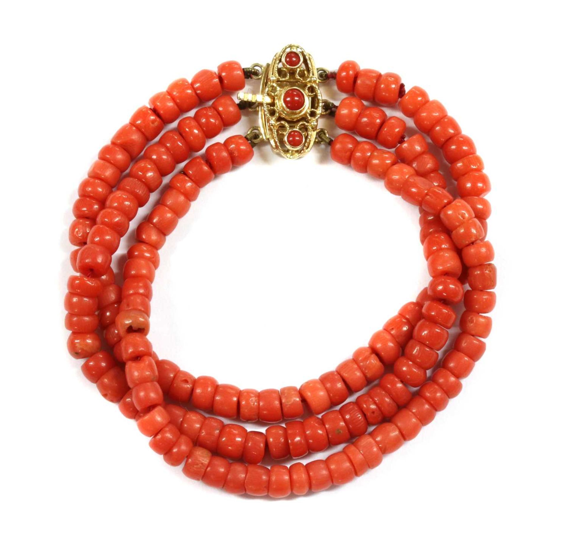 A three row uniform coral bead bracelet,