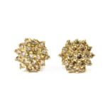 A pair of gold diamond cluster earrings,