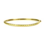 A 22ct gold oval bangle,