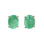 A pair of white gold single stone emerald stud earrings,